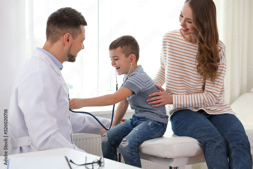 Mother and son visiting pediatrician. Doctor working with patient in hospital Mother and son visiting pediatrician. Doctor working with patient in hospital