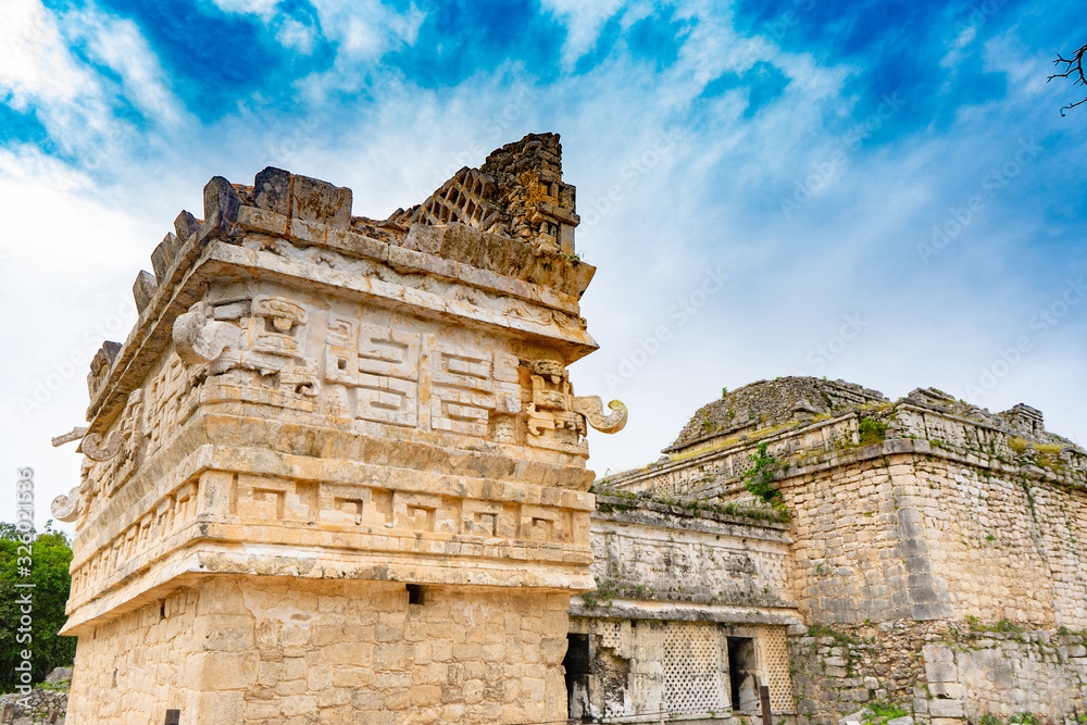 A small temple (La Iglesia) decorated with elaborate masks. Chichen Itza archaeological site. Architecture of ancient maya civilization. Travel photo or wallpaper. Yucatan. Mexico.