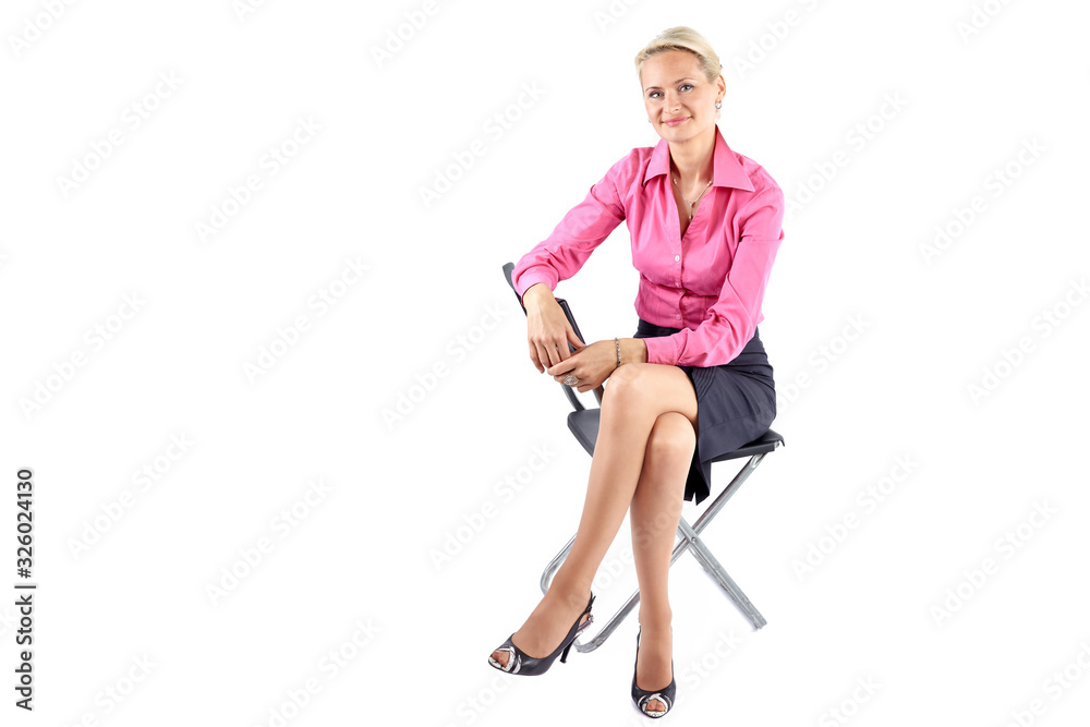 Fototapeta premium Smiling successful businesswoman sitting on a black chair on white background