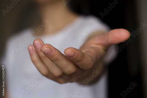 young woman's hand reaching out photo