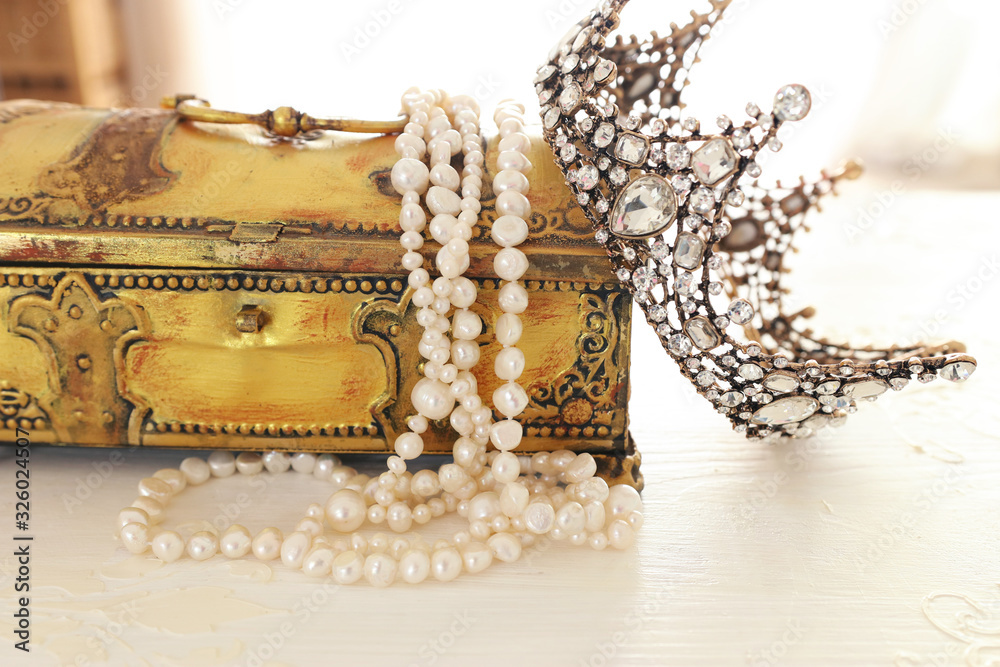 Vintage crown, antique jewellery box and pearls necklace. Wedding concept.  Back light Stock-Foto | Adobe Stock