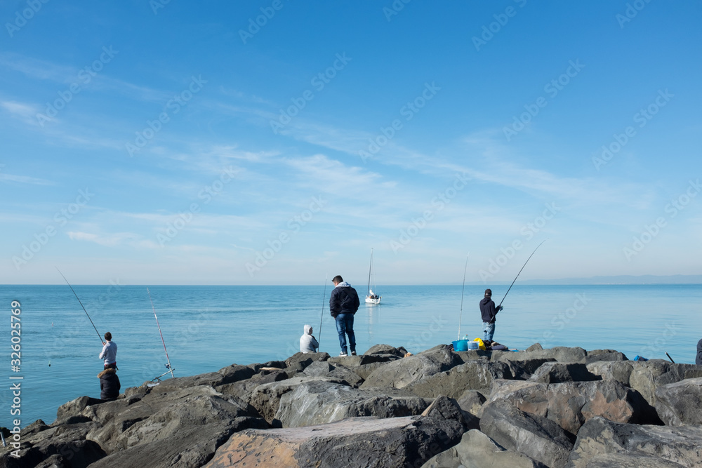 fisherman in front of the sea