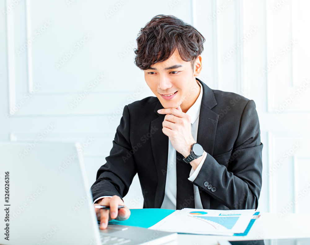 young man sitting at his desk in the office young man sitting at his desk in the office
