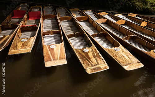The prows of wooden punts on the River Avon