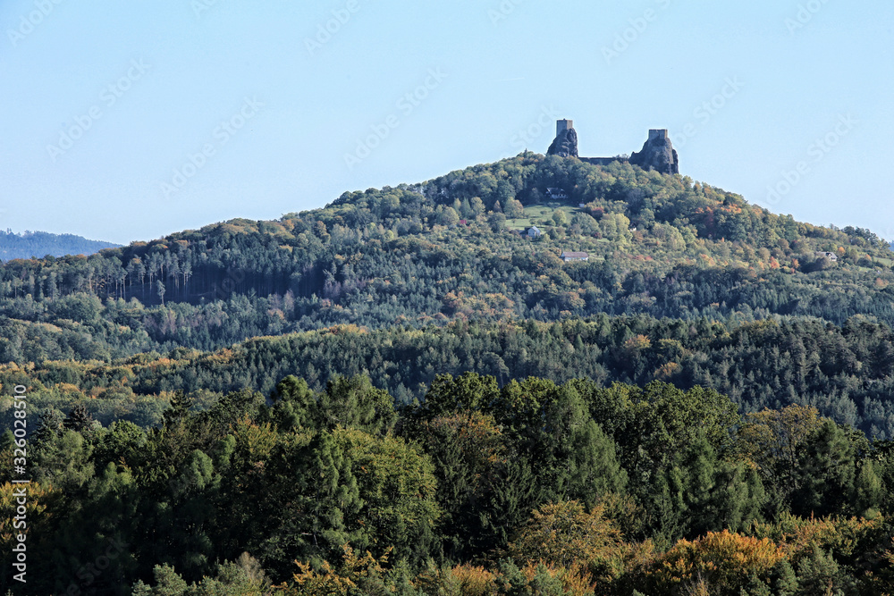 Distant towers to Trosky castle ruins on the top of hill