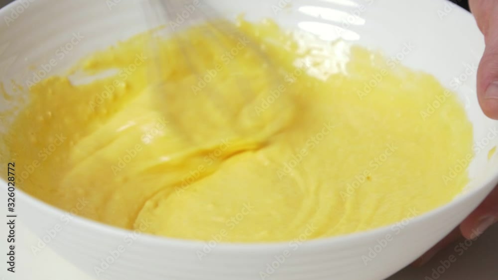 Corn flour crepes dough Mixing with metal whisk in white bowl Corn flour crepes dough Mixing with metal whisk in white bowl