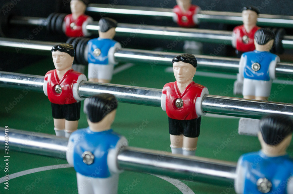 Blue and red little man players with a foosball macro shot Blue and red little man players with a foosball macro shot