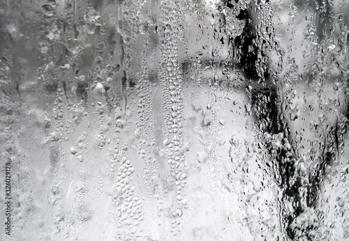 Gray background. Window with raindrops.