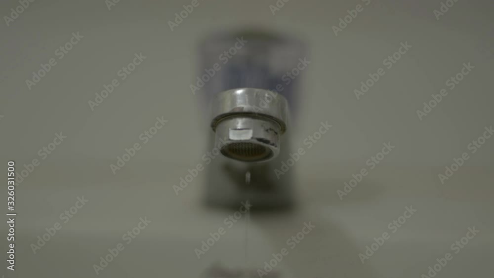 Close up dripping tap from faucet in the bathroom. Water saving concept. Close up dripping tap from faucet in the bathroom. Water saving concept.