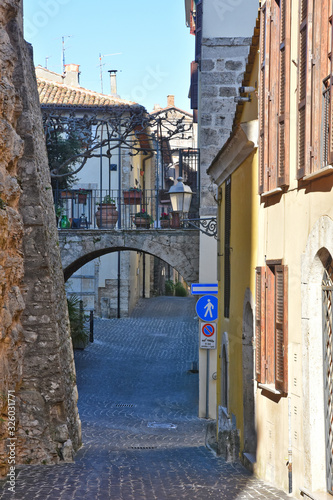 A narrow street between the old stone houses of a medieval village.