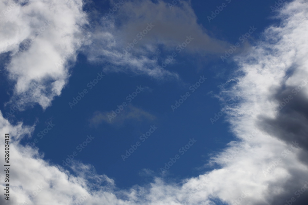 Fototapeta premium Clear blue sky with cumulus and cirrus clouds. Sunny weather. Joyful mood. High pressure. Clean air ecology. Water in a gaseous state. The source of rain and hail. Weather prediction