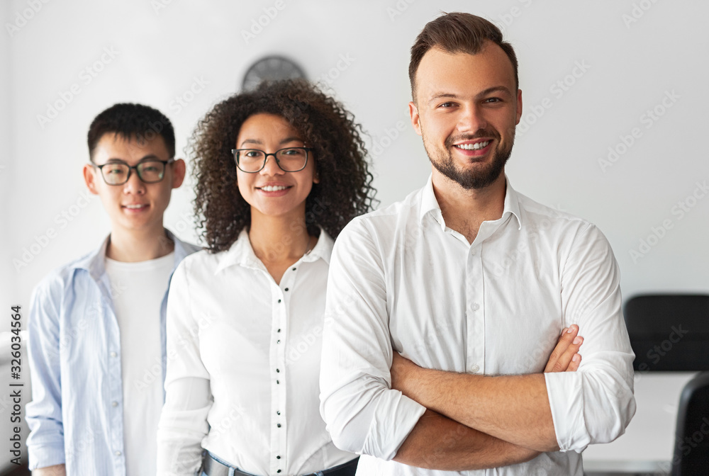 Modern positive business team looking at camera Modern positive business team looking at camera
