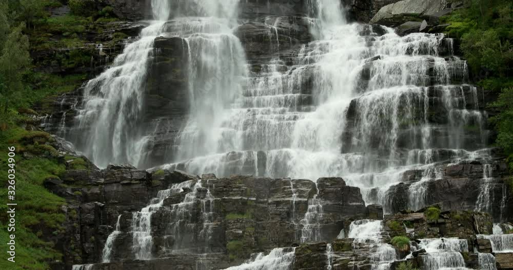 Voss, Hordaland, Norway. Waterfall Tvindefossen In Spring. Largest And Highest Waterfall Of Norway. Famous Natural Norwegian Landmark And Popular Destination. Tilt. close up view Voss, Hordaland, Norway. Waterfall Tvindefossen In Spring. Largest And Highest Waterfall Of Norway. Famous Natural Norwegian Landmark And Popular Destination. Tilt. close up view