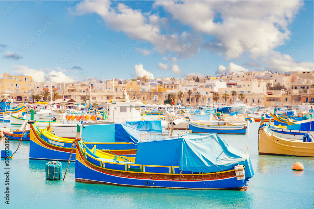 Mediterranean traditional fishing boats retro colorful on Marsaxlokk harbor Malta summer