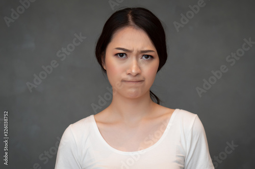 Konstfotografi face portrait of sad unhappy girl; portrait of upset angry frustrated Chinese or
