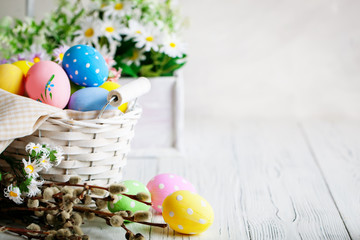 Happy Easter. Congratulatory easter background. Easter eggs and flowers. Background with copy space. Selective focus.