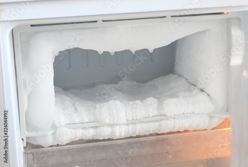 Ice full in empty freezer of a refrigerator makes refrigerator work harder and broken.