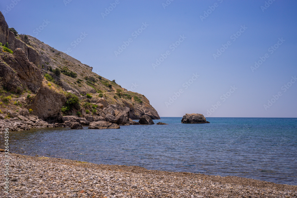 Seascape with rocks on the background of water