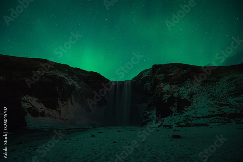 Beautiful Aurora at Skogafoss (Skoga Waterfall) in Iceland