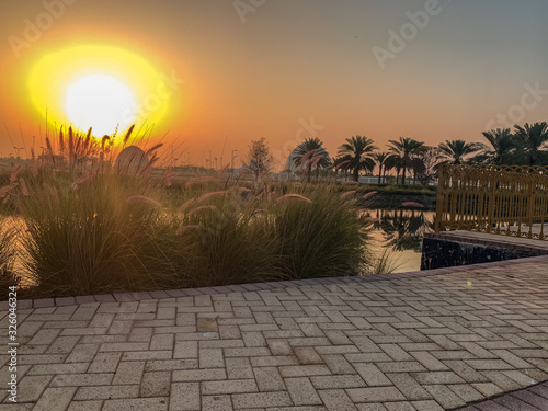 sunrise behind the sheikh zayed grand mosque entrance dome 