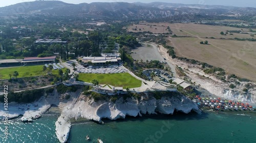 Drone Flying Away From the Shore in Summer Day. Beautiful Seaside Hotels with Parks and Beaches.