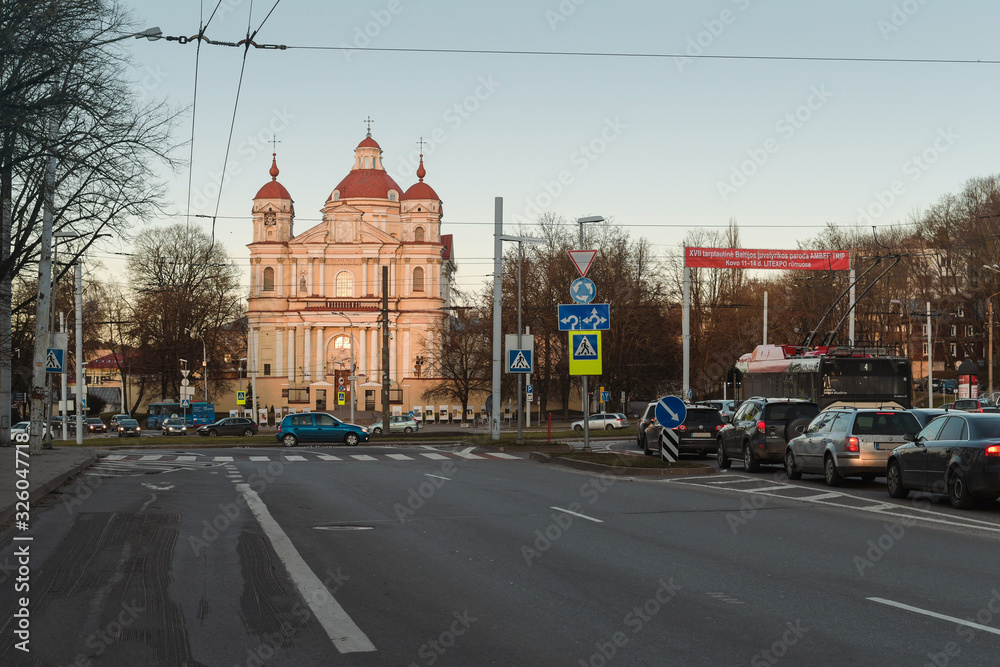 Obraz premium The Church of St. Peter and St. Paul in Vilnius Lithuania and traffic time