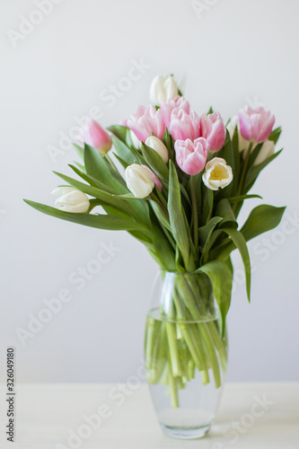 Bouquet of pink and white tulips in vase.
