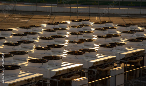 many large industrial air conditioner. compressor machine part of air conditioner system. Industrial air conditioner condensers (outside unit) on the roof of a building on a hot summer day