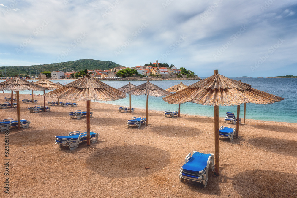 Scenic view of the beach and old town of Primosten with medieval architecture, famous tourist sea resort on Adriatic seacoast, Dalmatia, Croatia. Outdoor travel background, summer holiday concept Scenic view of the beach and old town of Primosten with medieval architecture, famous tourist sea resort on Adriatic seacoast, Dalmatia, Croatia. Outdoor travel background, summer holiday concept