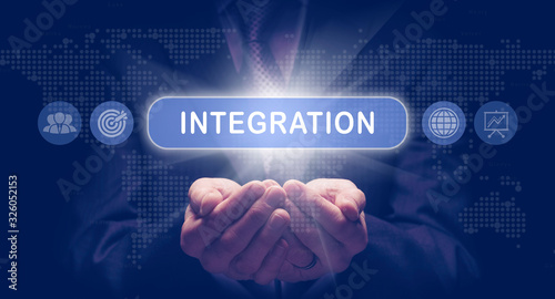 Fotografie Businessmans cupped hands holding an Integration business concept on a computerised display