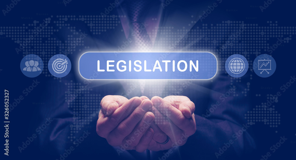 Businessmans cupped hands holding an Legislation business concept on a computerised display. Businessmans cupped hands holding an Legislation business concept on a computerised display.