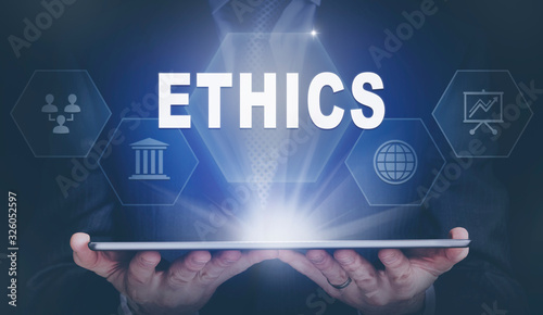 Konstfotografi Businessman holding a computer tablet display projecting a Ethics concept
