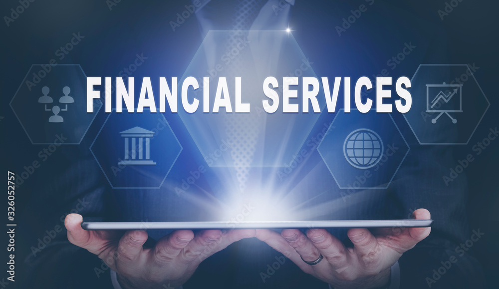 Businessman holding a computer tablet display projecting a Financial Services concept.