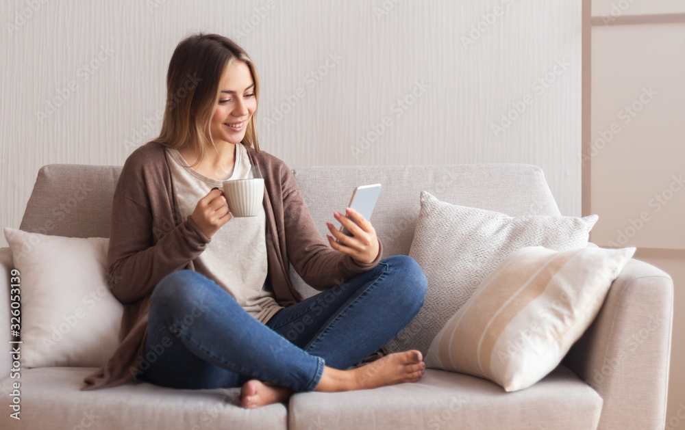 Cute woman browsing on cellphone with coffee Cute woman browsing on cellphone with coffee