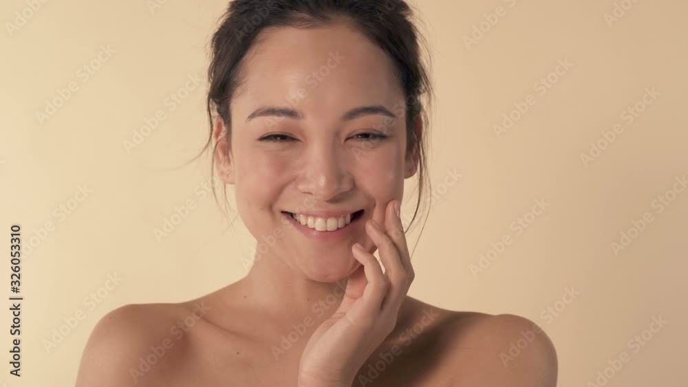 Portrait of smiley, cute and pretty woman. Showing a little bit shy emotion. Beije background. Portrait of smiley, cute and pretty woman. Showing a little bit shy emotion. Beije background.