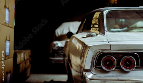 Retro cars in an old dark warehouse