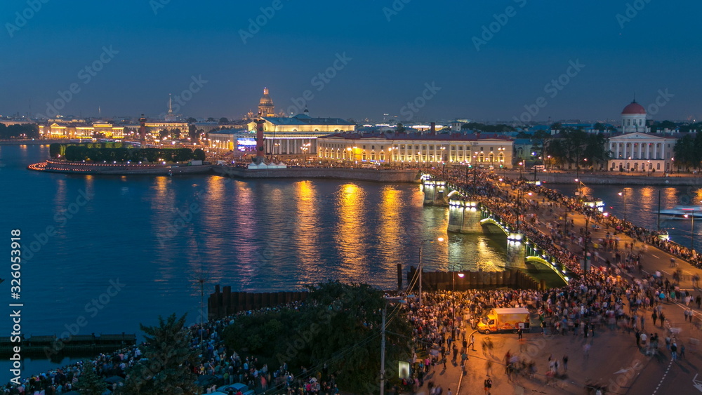 Night view of spit of Vasilyevsky Island and Birzhevoy Bridge with rostral column timelapse, Saint Petersburg, Russia.