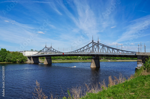 Russia, Tver city. View of the Starovolzhsky bridge at summer time, bright sunny day, scenicl blue sky. Old metal bridge over the Volga river is one of the Tver's symbols