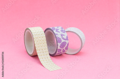 decorative tape for scrapbooking. Design albums, notebooks, diaries. Adhesive tape with glitter, gold, silver. on a pink background
