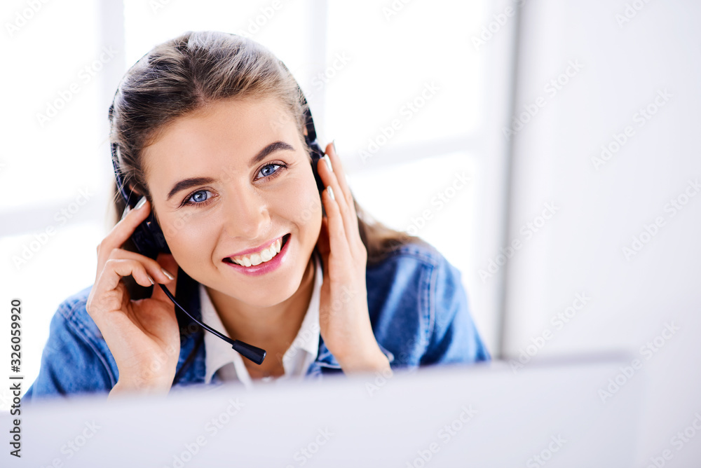 Smiling beautiful woman working at call center in office Smiling beautiful woman working at call center in office