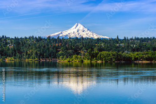 Mt Hood covered with snow over Hood River and reflecting on the Columbia River, Oregon. Shot taken from Washington state. USA.