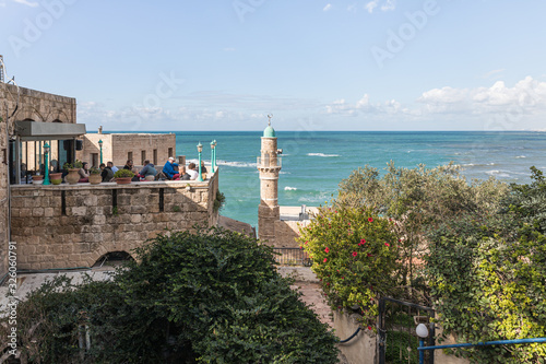 The open veranda of the Aladdin restaurant and the Al Bahr Mosque on the embankment in old Yafo in Israel