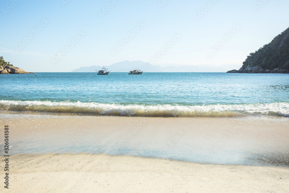 Vacation on the Meros(praia dos Meros) beach with clean sand, turquoise ocean water and blue sky with clouds on a sunny day. Panoramic view of the beach in Ilha Grande, south of Rio de Janeiro, Brazil