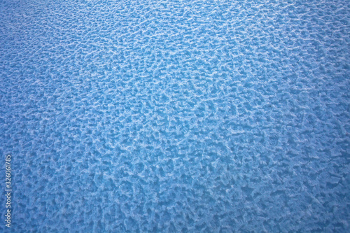 Background of frozen snow texture in blue tone field