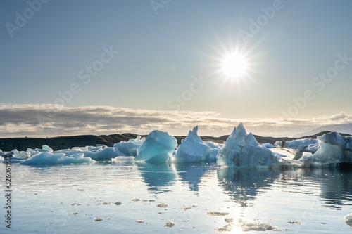Ice glacier floating reflect on lagoon lake with beautiful sunstar clear sky at jokulsarlin glacier lagoon, Iceland