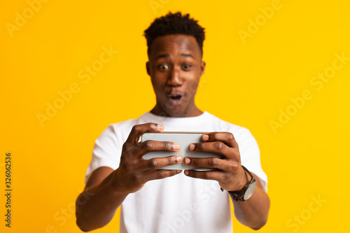 Emotional african guy playing video games online