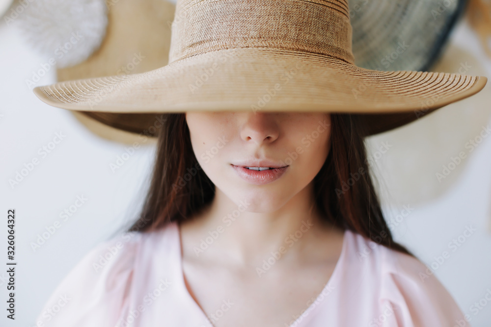 Young pretty happy woman in a dress. A beautiful smiling girl in a hat. Romantic shot. Fashion style photo of a spring women