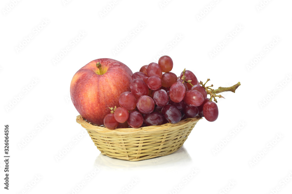 Red grapes and apple in bamboo basket isolate on white background. Red grapes and apple in bamboo basket isolate on white background.