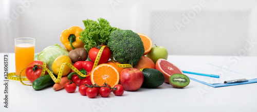 Nutritionist's workplace with fruits, vegetables, measuring tape on table