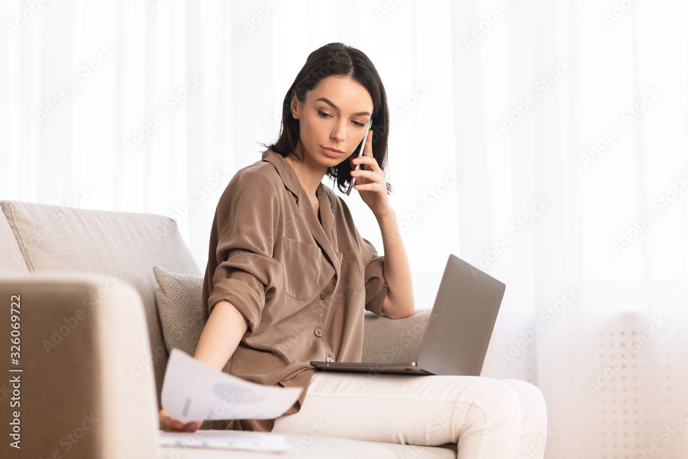 Young woman talking on cellphone sitting on the sofa Young woman talking on cellphone sitting on the sofa